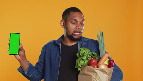 African-american-man-showing-a-phone-with-isolated-mockup-screen