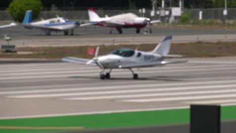 small airplane takes off from runway