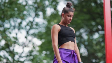 woman performing calisthenics workout in park