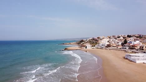 the stunning beach of cava d'aliga in sicily, drone soaring high, sunny