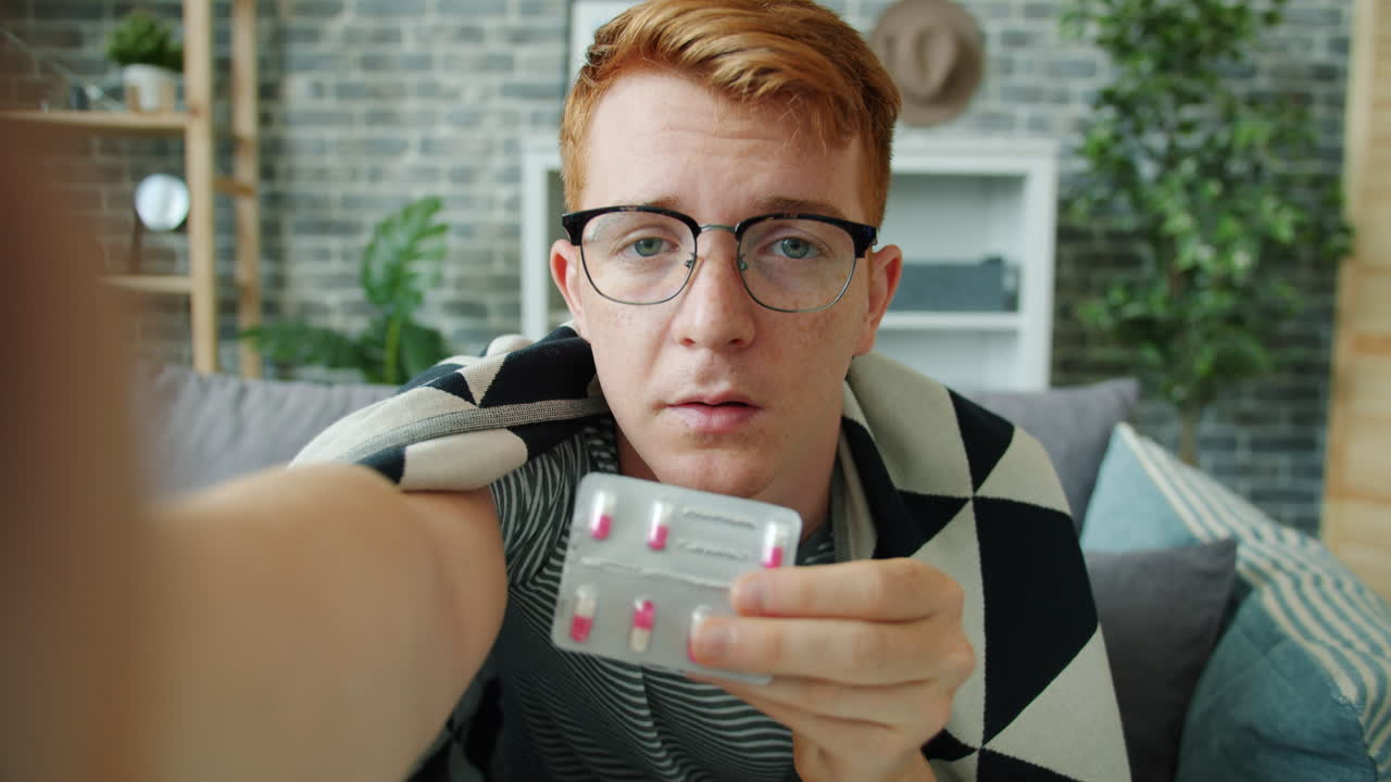 Young Man Taking Medication at Home