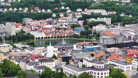 Aerial-View-of-Residential-Neighborhood-of-Bergen,-Norway,-Lake,-Fountain,-Buildings-and-Train-Station,-Drone-Shot-60fps