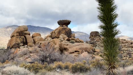 red rock formations with a mountain background on a cloudy overcast day in the yucca valley desert in southern california static