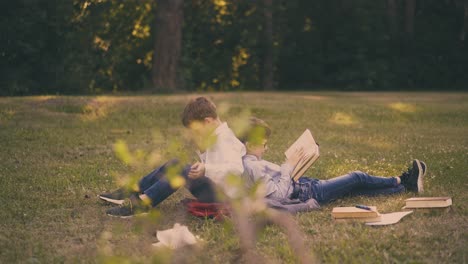 schoolmates-tired-of-preparing-for-tests-sit-on-fresh-lawn