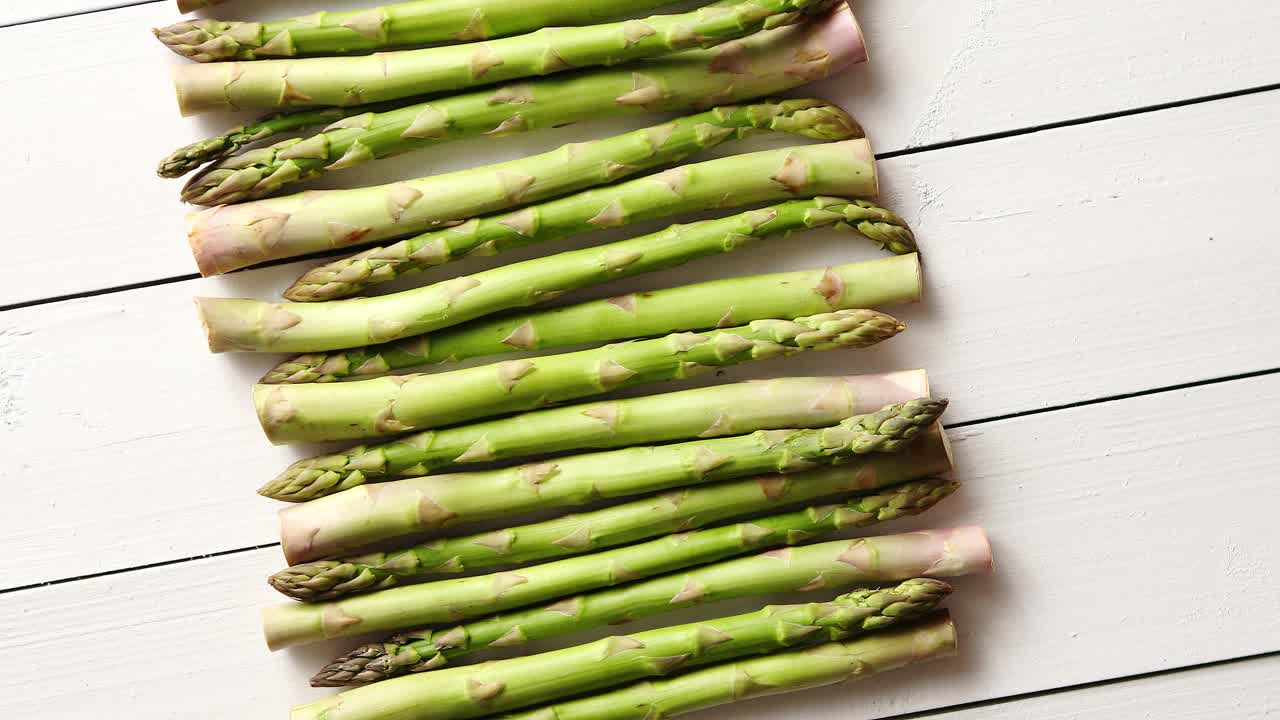 Above view of flat lay organic raw uncooked green asparagus
