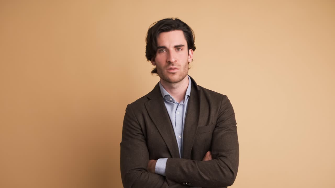 Disagreeing adult businessman shaking head in brown studio