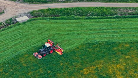 tractor working on farm land - aerial drone shot