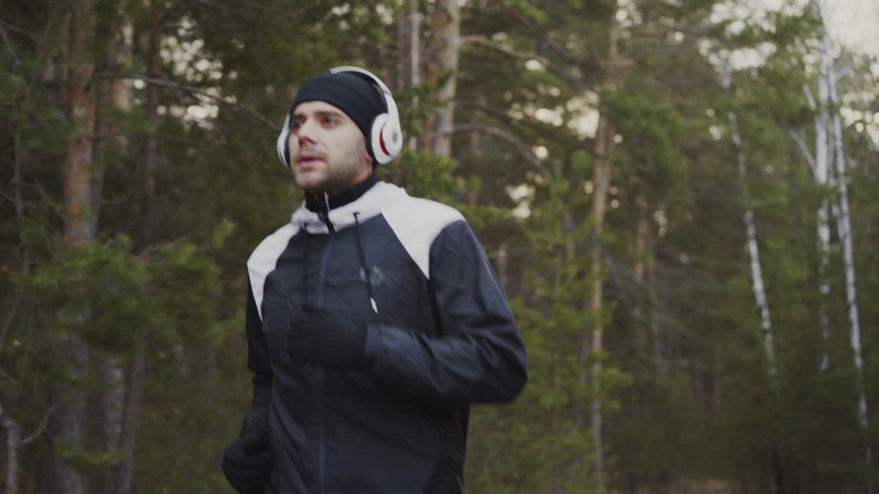 Man Running in a Forest in Winter