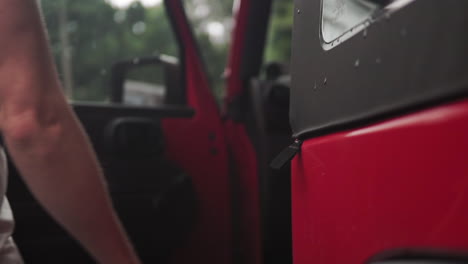 close up mans hand opening car door and getting inside