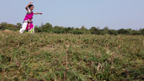 A-bharatnatyam-dancer-displaying-a-classical-bharatnatyam-pose-in-the-nature-of-Vadatalav-lake,-Pavagadh