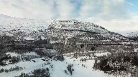 Snow-Mountain-With-Blue-Cloudy-Sky-In-Norway---aerial-shot