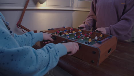 kids play miniature table football