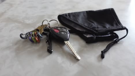 black mask and keys on marble counter, no persons