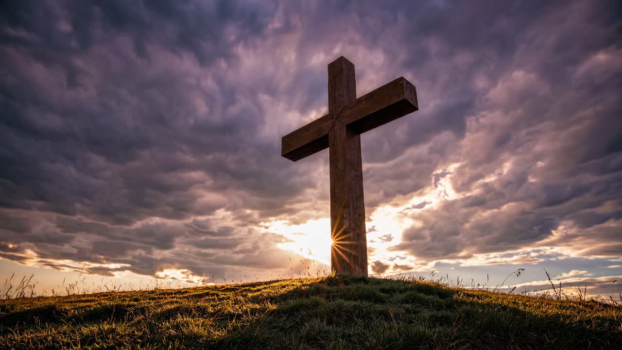 Dramatic low-angle shot of a wooden cross on a hill, with sun rays and stormy clouds