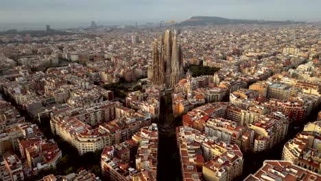 a cinematic aerial drone shot of the entire catalonia featuring la sagrada familia in barcelona spain