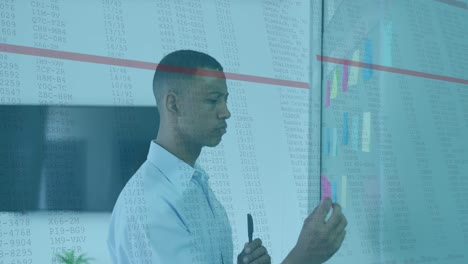 animation of data processing against african american man sticking memo notes at office