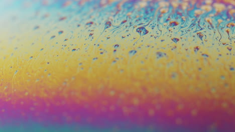 liquid showing a colors of the rainbow and moving in slow motion