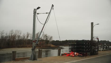 bouys and lobster traps with cargo lift on pier, 4k video