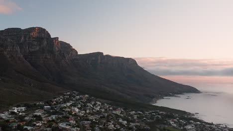 aerial of bakoven with in the background table mountain (nature reserve) with sunset in cape town