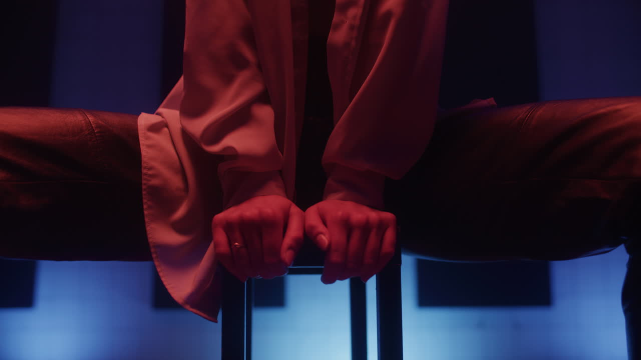 Person Sitting on a Piano Stool in a Colorful Studio Setting