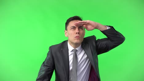 businessman looking into the distance on green screen