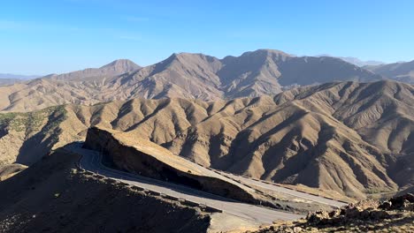 high angle aerial view panning across road in atlas mountains morocco