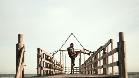 man stretching his leg on the promenade