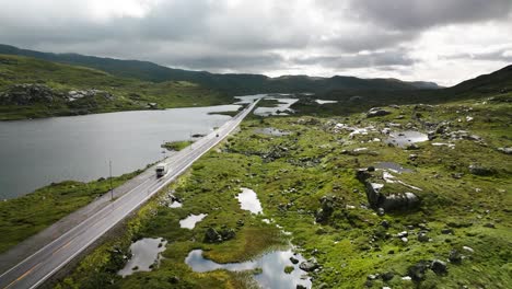 norwegian road, cars driving, sun and clouds, summer day