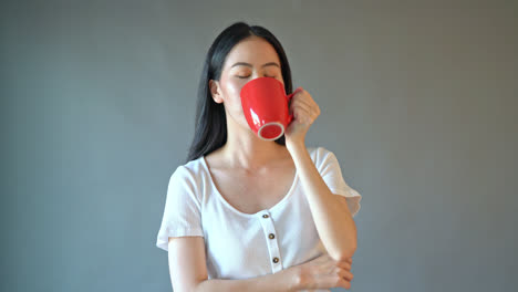 young asian woman with happy face and hand holding coffee cup