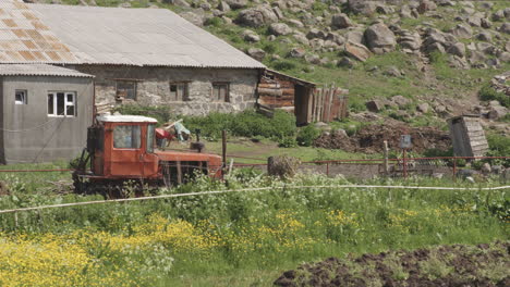 Old-And-Abandoned-Farm-Tractor-In-Rural-Village