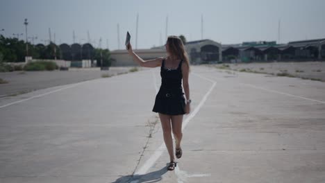 young woman taking selfies on a street