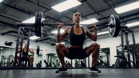 woman performing barbell back squat