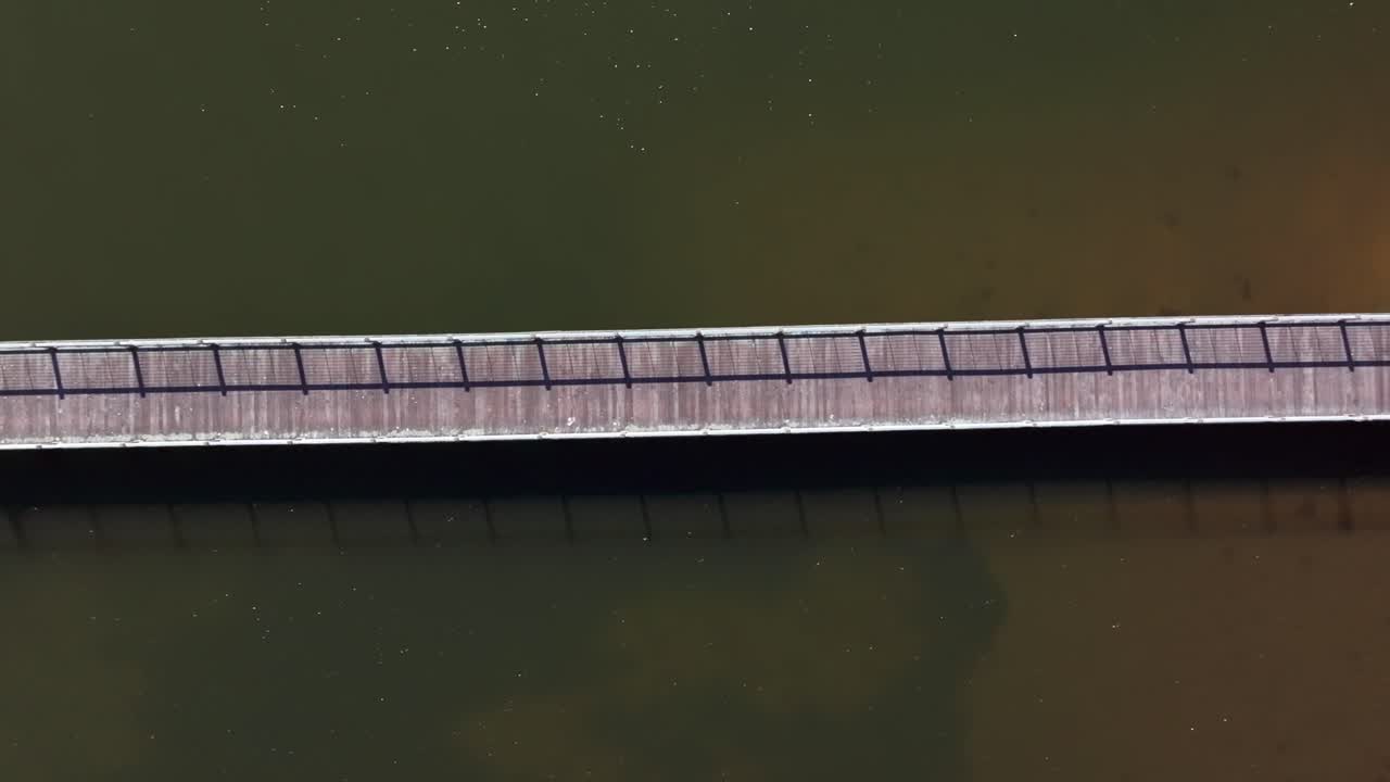 A high angle top down view of a wooden pier on Oyster Bay, Long Island on a sunny day