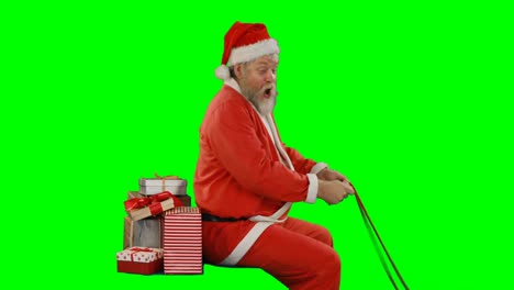 Santa-claus-with-gift-box-riding-on-green-screen