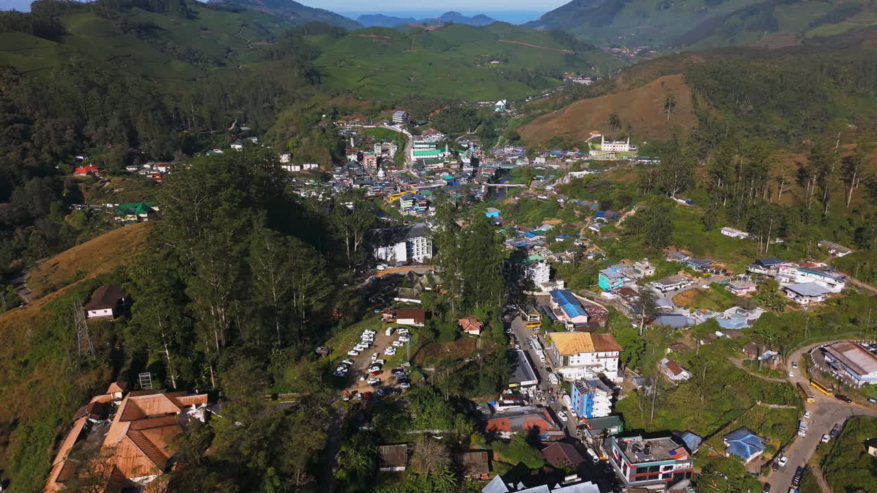 Aerial view rising over over streets of the Munnar hill station, golden hour in India