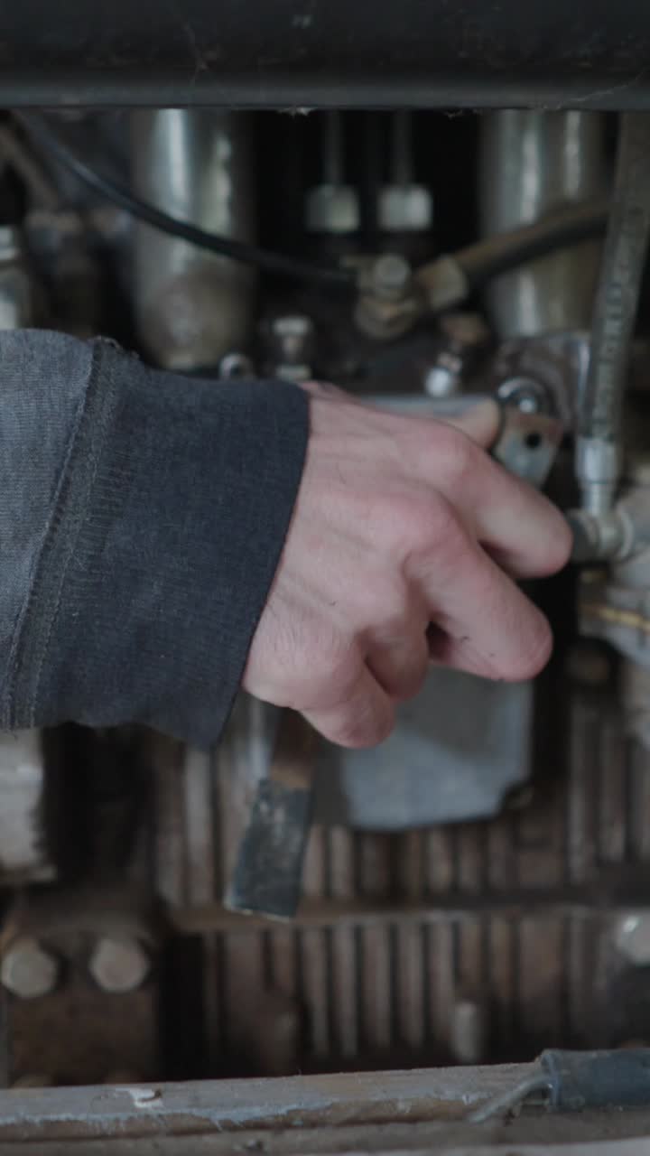 Close-up of a hand working on an engine