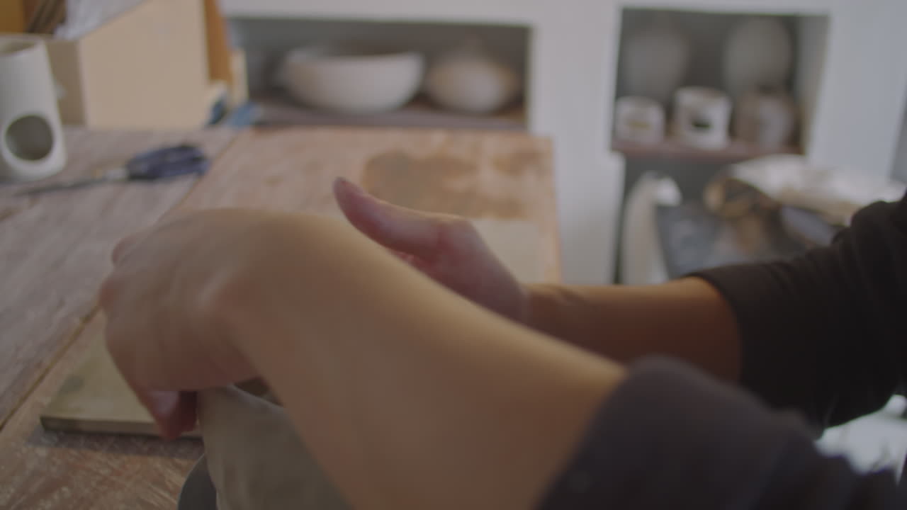 Young Asian Ceramist Making Mug on Pottery Wheel