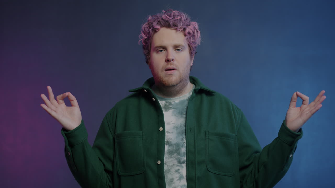 Man Meditating in a Green Jacket