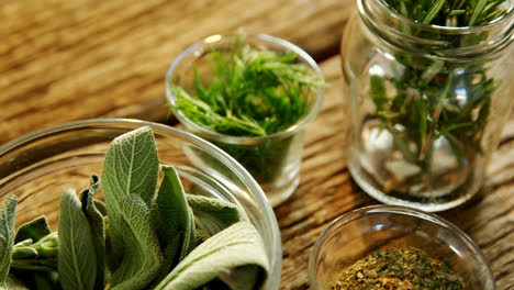 various herbs in a jar on wooden table 4k