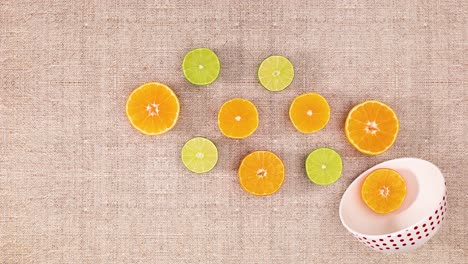 white bowl and moving slices of orange and lime. stop motion