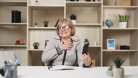 older-woman-chats-happily-on-a-video-call-through-her-smartphone