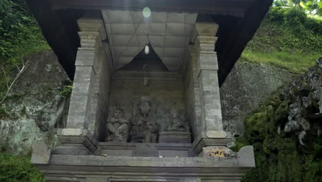 slow motion establishment shot of a balinese pavilion bale kulkul in a historic sacred temple on bali indonesia