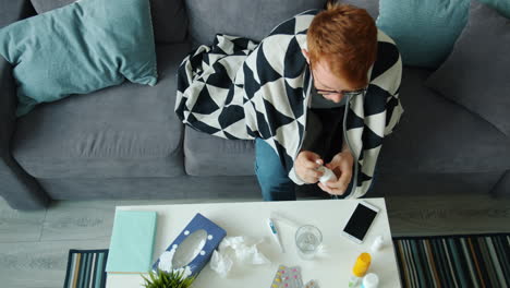 sick person taking medication at home