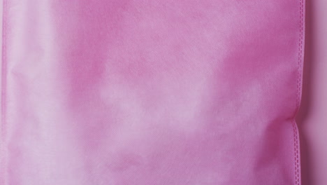 video of pink canvas bag with copy space on pink background