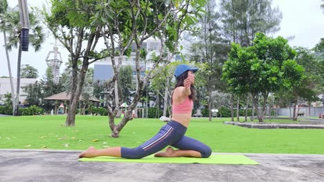 woman doing yoga in a park