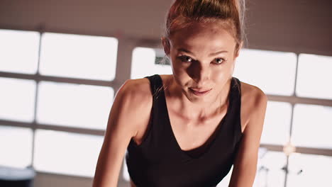 Slow-Motion-Of-Determined-Young-Woman-Cycling-On-Stationary-Bike-At-Gym