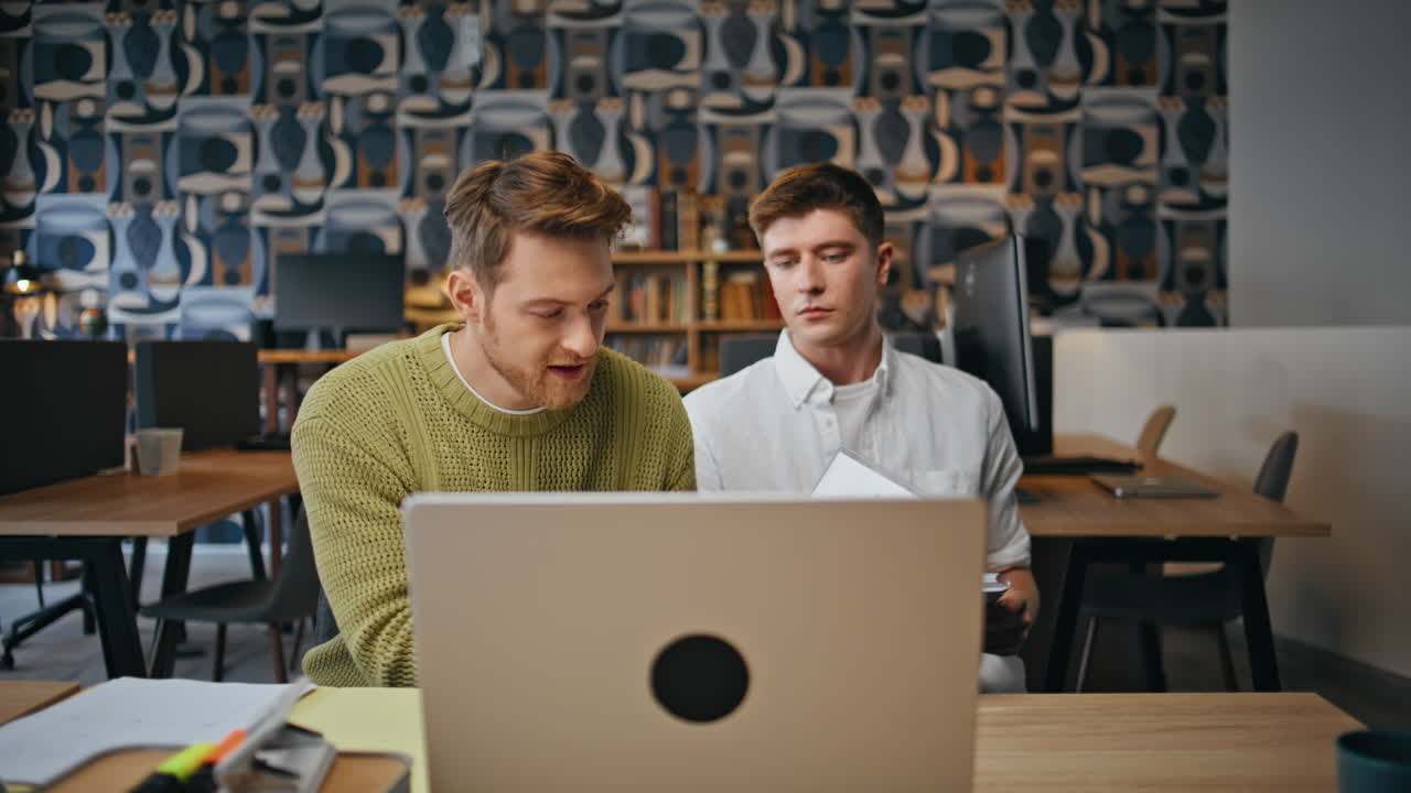 Emotional partners staring computer screen office closeup. Creators video call