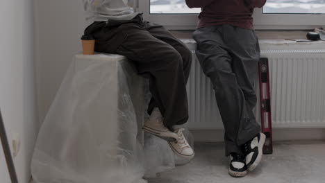 couple taking a coffee break during home renovation