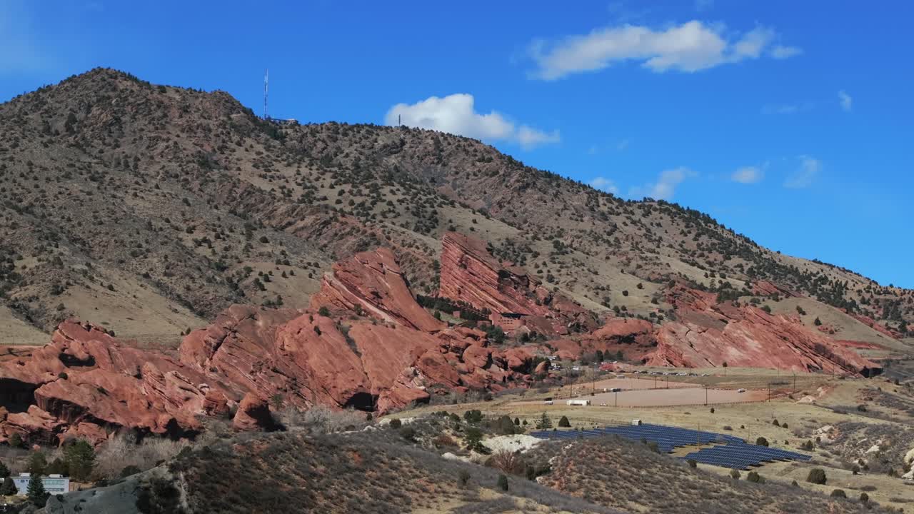 Morrison Colorado aerial drone Red Rocks Park and Amphitheater mid winter no snow Mount Morrison Bear Creek trails Trading Post sunny blue sky clouds solar panel parking lot upward motion