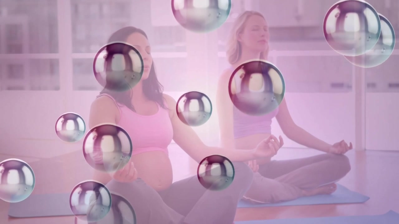 Women initiating meditation closing eyes and forming mudra on mats with bubbles drifting over scene